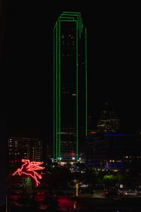 Night View of Bank of America Plaza Building and Omni Hotel Neon Mobil Pegasus Flying Horse in Downtown Dallas Texas